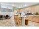 Spacious kitchen features light wood cabinets, stone floors, and a breakfast nook at 6409 Sea Swallow St, North Las Vegas, NV 89084