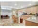 Charming kitchen with a central island, tiled floors, and an adjacent dining area at 6409 Sea Swallow St, North Las Vegas, NV 89084