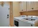 Laundry room with a washer and dryer and overhead cabinets at 6409 Sea Swallow St, North Las Vegas, NV 89084