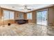 Spacious living room with a ceiling fan, tiled floors, and a sliding glass door at 6409 Sea Swallow St, North Las Vegas, NV 89084