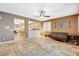 Open living space with a ceiling fan, tiled floors, and views of the kitchen at 6409 Sea Swallow St, North Las Vegas, NV 89084