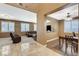 Open-concept living room with neutral tones, large windows, and hardwood flooring, ideal for entertaining at 6409 Sea Swallow St, North Las Vegas, NV 89084