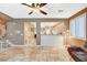 Open living space with tiled floors, staircase access, and views into the kitchen at 6409 Sea Swallow St, North Las Vegas, NV 89084