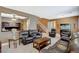 Comfortable living room featuring leather furniture, a ceiling fan, and staircase access at 6409 Sea Swallow St, North Las Vegas, NV 89084