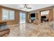 Bright living room with tiled floors, sliding glass doors, and built-in shelving at 6409 Sea Swallow St, North Las Vegas, NV 89084
