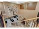 Overhead view of the loft area with stylish seating, staircase, and decorative wall art at 6409 Sea Swallow St, North Las Vegas, NV 89084