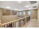 Bright upstairs loft with decorative railing, wall accents, and wood-look flooring at 6409 Sea Swallow St, North Las Vegas, NV 89084