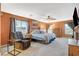 Spacious main bedroom with cozy sitting area, neutral carpet, ceiling fan and natural light at 6409 Sea Swallow St, North Las Vegas, NV 89084