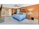 Bright main bedroom suite featuring a ceiling fan, and a peek into the connected bathroom and closet at 6409 Sea Swallow St, North Las Vegas, NV 89084