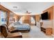 Large main bedroom featuring a ceiling fan, sitting chair, dresser, and bright windows at 6409 Sea Swallow St, North Las Vegas, NV 89084