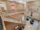 Open staircase leading to a loft area with stylish black railings, and neutral toned walls at 6409 Sea Swallow St, North Las Vegas, NV 89084
