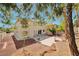 The backyard has desert landscaping, a concrete patio, and views of the two-story home at 6509 Alpine Winter Ct, Las Vegas, NV 89149