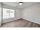 Bright bedroom features light gray wood flooring and a large window with horizontal blinds at 6509 Alpine Winter Ct, Las Vegas, NV 89149