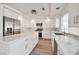 Stylish kitchen with white cabinets, stainless steel appliances, marble countertops, and a kitchen island at 6509 Alpine Winter Ct, Las Vegas, NV 89149