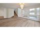 Open living room with wood-look floors, a decorative mirror and staircase leading to the upper level at 6509 Alpine Winter Ct, Las Vegas, NV 89149