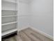 Bright walk-in closet features modern shelving and neutral decor at 6509 Alpine Winter Ct, Las Vegas, NV 89149