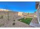 Serene backyard with artificial grass, gravel, and a small seating area perfect for outdoor relaxation at 6533 Cinnamon Hazelnut St # Lot 94, North Las Vegas, NV 89084
