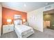 Well-lit bedroom with colorful accent wall, white furniture, and decorative artwork at 6533 Cinnamon Hazelnut St # Lot 94, North Las Vegas, NV 89084