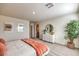 Bright bedroom with neutral walls, light-colored carpet, and a stylish white dresser with decorative mirror at 6533 Cinnamon Hazelnut St # Lot 94, North Las Vegas, NV 89084