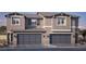 Charming paired home featuring a neutral palette, gray roof, gray garage doors and shutter, and manicured landscaping at 6533 Cinnamon Hazelnut St # Lot 94, North Las Vegas, NV 89084