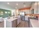 Spacious kitchen with an island, stainless steel appliances, gray cabinets, and ample countertop space for cooking at 6533 Cinnamon Hazelnut St # Lot 94, North Las Vegas, NV 89084
