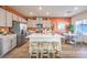 Well-lit kitchen features stainless steel appliances, an island with seating, and flows into the dining area at 6533 Cinnamon Hazelnut St # Lot 94, North Las Vegas, NV 89084
