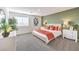 Serene main bedroom with a green accent wall, neutral furniture, and ample natural light for a relaxing retreat at 6533 Cinnamon Hazelnut St # Lot 94, North Las Vegas, NV 89084