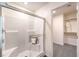 Bathroom shower with glass doors, white tile, and built-in shelving for toiletries at 6533 Cinnamon Hazelnut St # Lot 94, North Las Vegas, NV 89084