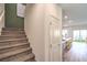 Carpeted staircase leading to the upper level, complemented by a white door and an open view of the kitchen at 6533 Cinnamon Hazelnut St # Lot 94, North Las Vegas, NV 89084