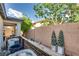 Backyard area showing AC units, fence, and some greenery at 680 Moonlight Stroll St, Henderson, NV 89002