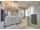 Bathroom with double sink vanity, shower and separate soaking tub at 680 Moonlight Stroll St, Henderson, NV 89002
