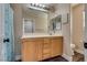 Bathroom featuring a large mirror, wooden cabinets, and a decorative shower curtain at 680 Moonlight Stroll St, Henderson, NV 89002