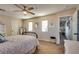 Comfortable bedroom featuring a ceiling fan, neutral walls, and plush carpet flooring at 680 Moonlight Stroll St, Henderson, NV 89002