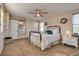 Inviting bedroom featuring a ceiling fan, plush carpet, and an ensuite bathroom at 680 Moonlight Stroll St, Henderson, NV 89002