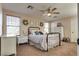Bedroom featuring a black metal bed frame, two windows, and ceiling fan at 680 Moonlight Stroll St, Henderson, NV 89002