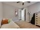 Bedroom featuring a twin bed, decorative mirror, and an open door at 680 Moonlight Stroll St, Henderson, NV 89002