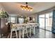 Spacious dining area with hardwood floors, a decorative light fixture, and access to the backyard at 680 Moonlight Stroll St, Henderson, NV 89002