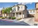 Charming two-story home featuring well-maintained landscaping and a welcoming front porch at 680 Moonlight Stroll St, Henderson, NV 89002