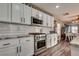 The kitchen features white cabinets, a gas range, granite countertops, and a decorative tile backsplash at 680 Moonlight Stroll St, Henderson, NV 89002