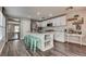 Modern kitchen with white cabinets, a large island, stainless steel appliances, and ample counter space at 680 Moonlight Stroll St, Henderson, NV 89002