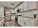 Modern kitchen with white cabinets, stainless steel appliances, and granite countertops at 680 Moonlight Stroll St, Henderson, NV 89002