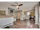 Inviting living room with wood flooring, a ceiling fan, and a staircase at 680 Moonlight Stroll St, Henderson, NV 89002