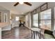 Inviting living room with wood flooring, a ceiling fan, and a staircase at 680 Moonlight Stroll St, Henderson, NV 89002