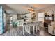Open-concept floor plan with dining area that connects to the kitchen with modern decor and hardwood floors at 680 Moonlight Stroll St, Henderson, NV 89002