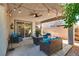 Relaxing covered patio with a ceiling fan, string lights, and comfortable seating at 680 Moonlight Stroll St, Henderson, NV 89002