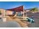 Well-equipped playground with a shade structure, slides, and fun animal sculptures for children at 680 Moonlight Stroll St, Henderson, NV 89002