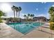 Large community pool with clear blue water, palm trees, and lounge chairs for relaxing at 680 Moonlight Stroll St, Henderson, NV 89002