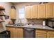 Well-lit kitchen features wood cabinets, granite countertops, and stainless steel appliances at 6955 N Durango Dr # 2081, Las Vegas, NV 89149