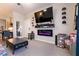Relaxing living room features a modern electric fireplace, television and comfortable seating at 6955 N Durango Dr # 2081, Las Vegas, NV 89149