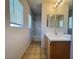 This bright bathroom features a tub-shower combo, a single sink, and window views at 7249 Old Glory St, Las Vegas, NV 89148